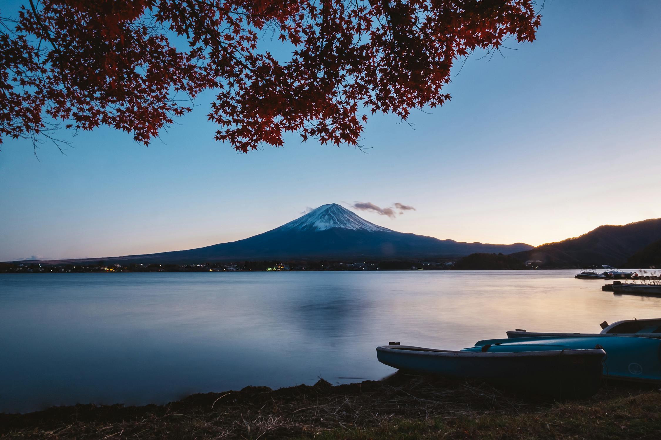 Mirror-like reflection of Mount Fuji in Lake Kawaguchiko, Yamanashi, Japan. A classic and serene view of Japan's iconic mountain.