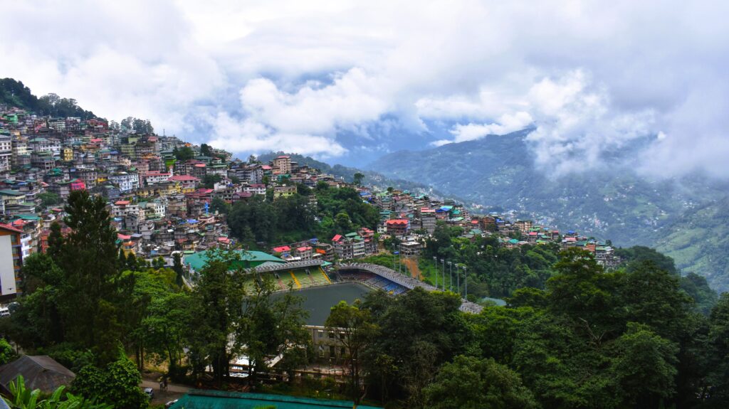 Panoramic view of Gangtok city surrounded by Himalayan mountains during a Sikkim tour
