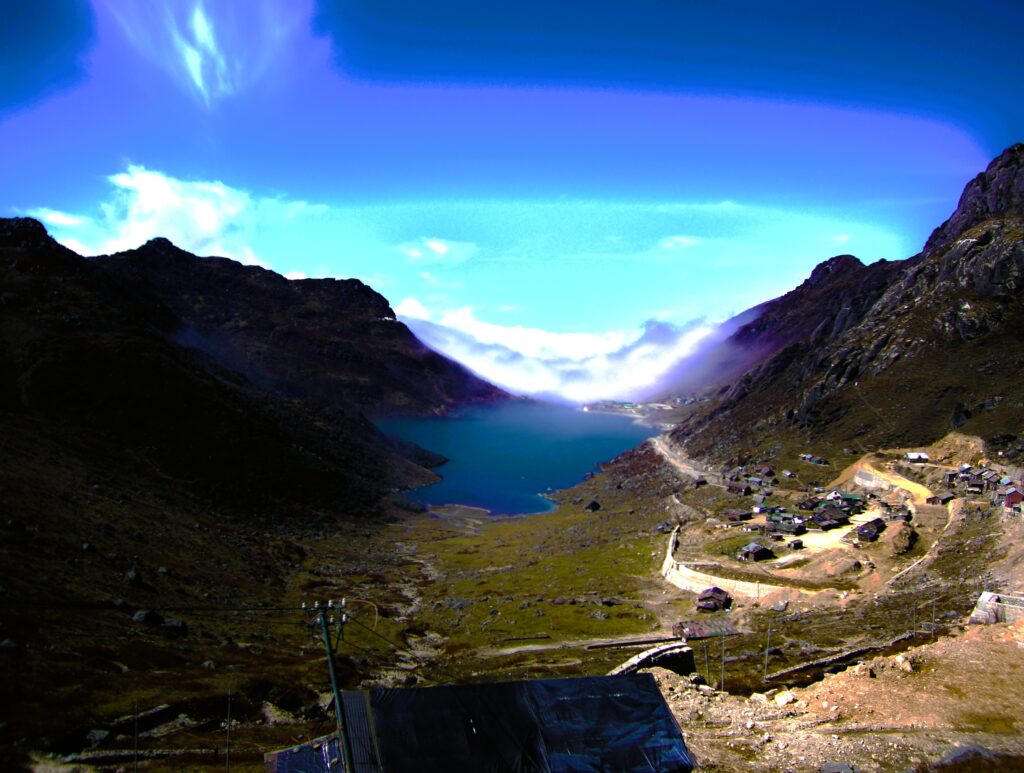 Tsomgo Lake in East Sikkim surrounded by snow-covered mountains and clear blue water