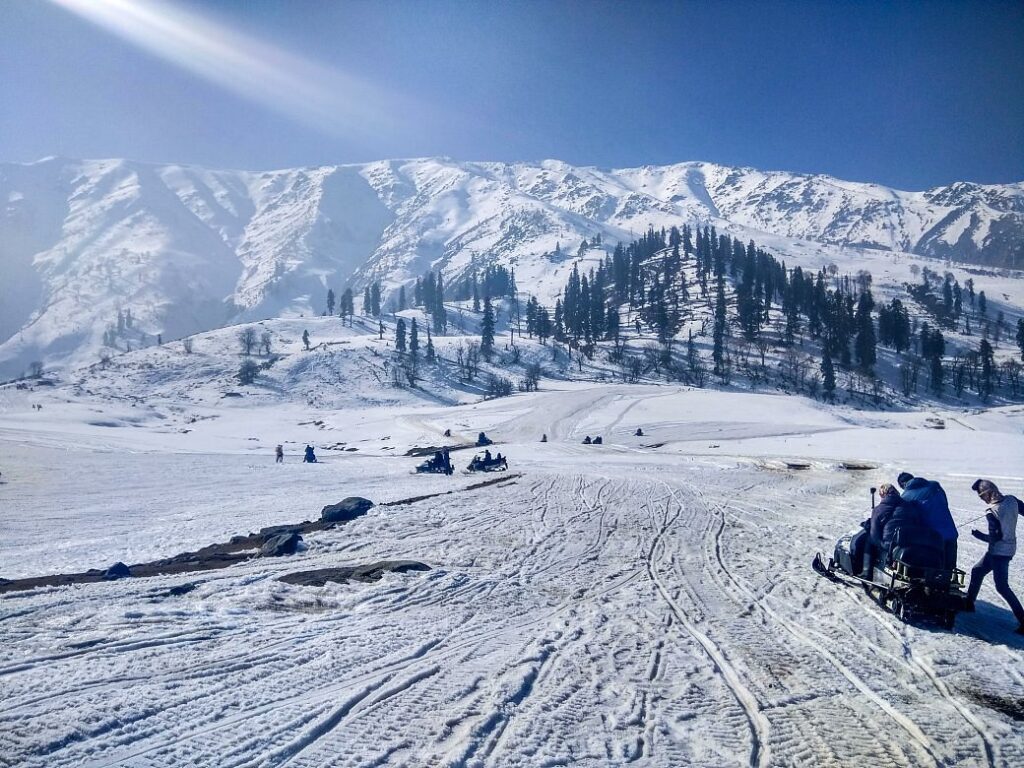 Indian Himalayas, A close-up view of a dramatic mountain summit covered in deep wind-swept snow and ice.