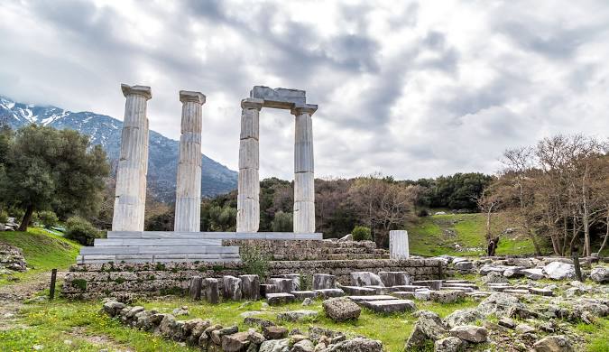 Ancient columns of the Sanctuary of the Great Gods in Samothraki, Greece. Explore historical sites on your travel blog.