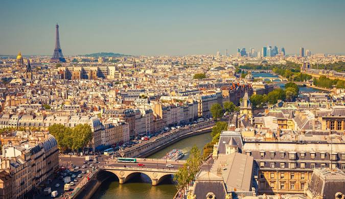 Panoramic Paris cityscape featuring the Seine River, bridges, and the Eiffel Tower in the distance - travel blog view