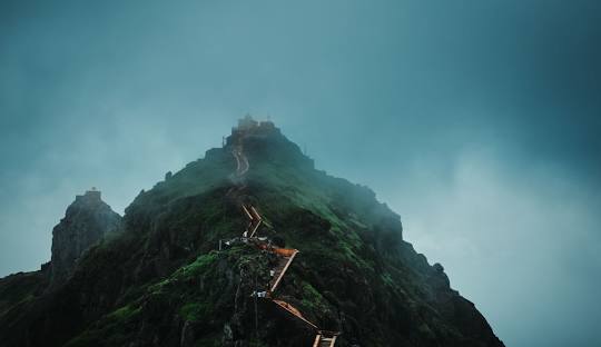 Fog-covered trail to Girnar Hills temple summit during monsoon season