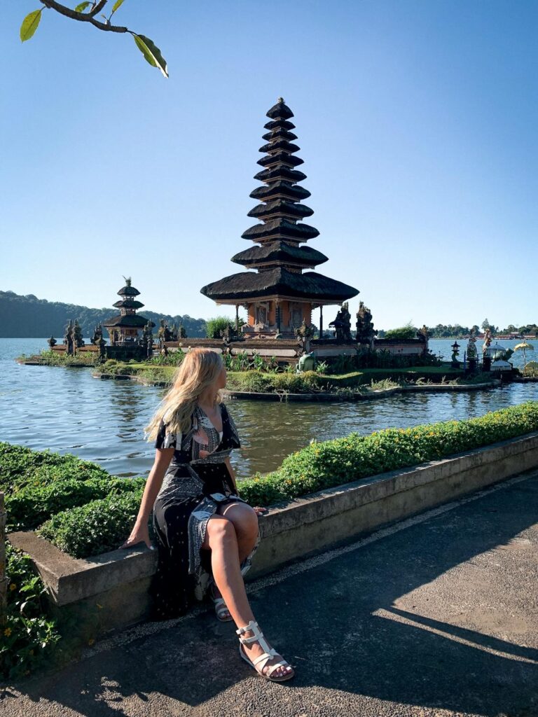 Balinese temple silhouetted against a vibrant sunset sky at Uluwatu. Discover cultural landmarks in Bali.