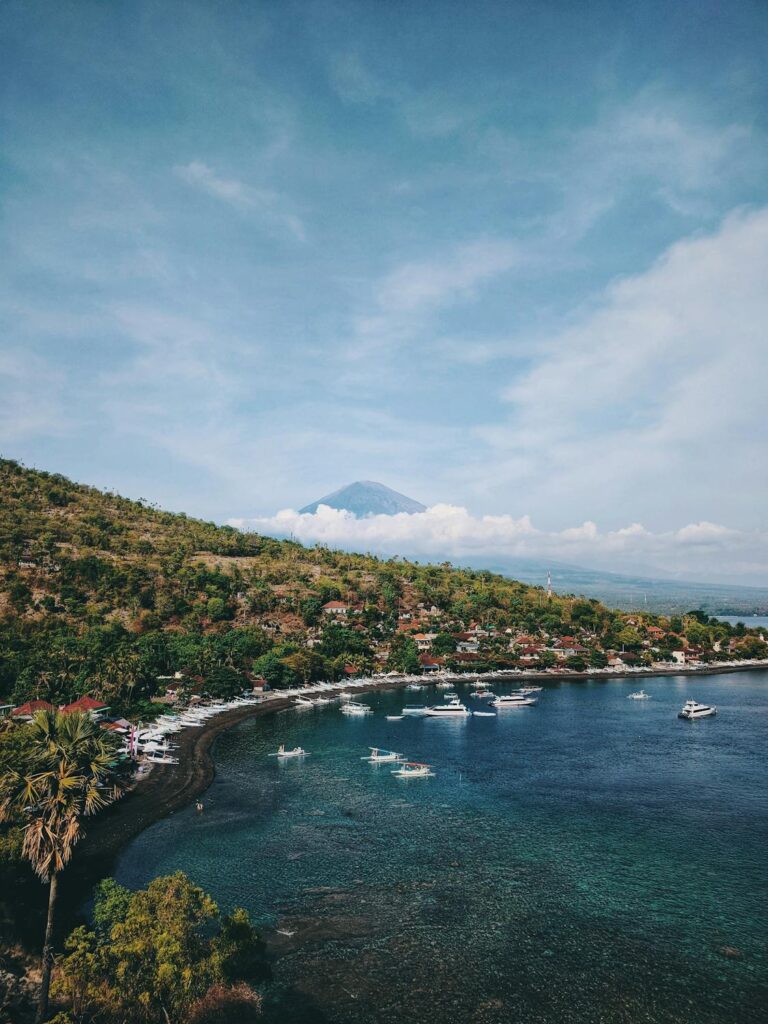 Sandy shores of Kuta Beach in Bali, bustling with surfers. Enjoy beach activities during your Bali vacation.