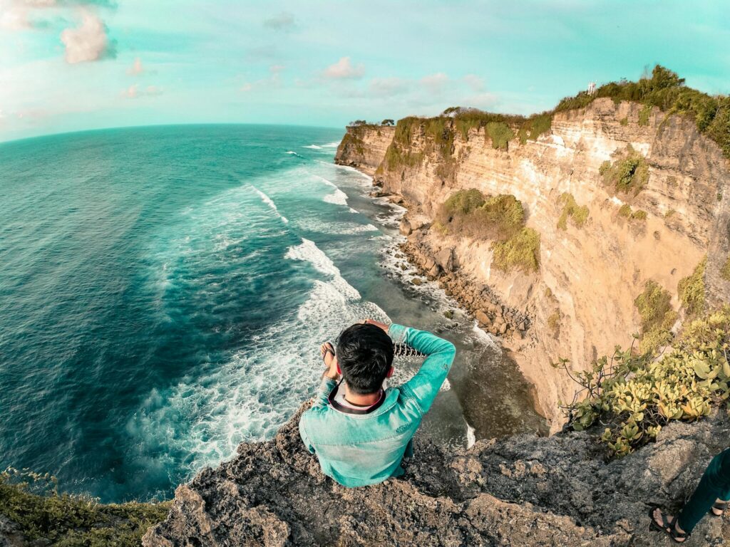 Sandy shores of Kuta Beach in Bali, bustling with surfers. Enjoy beach activities during your Bali vacation.