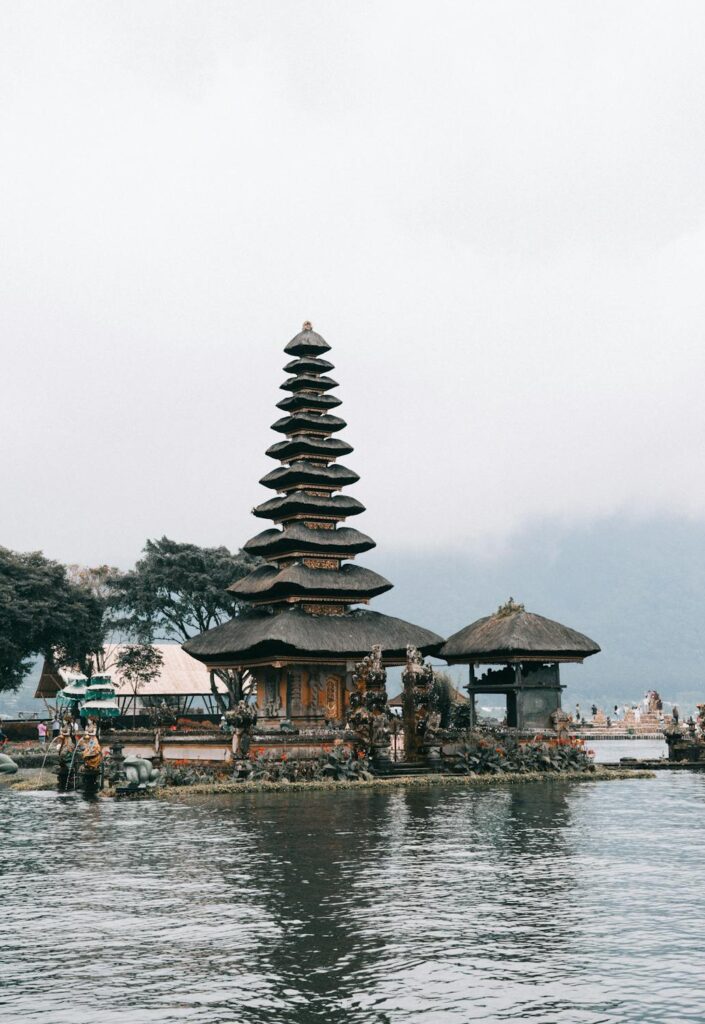 Balinese temple silhouetted against a vibrant sunset sky at Uluwatu. Discover cultural landmarks in Bali.
