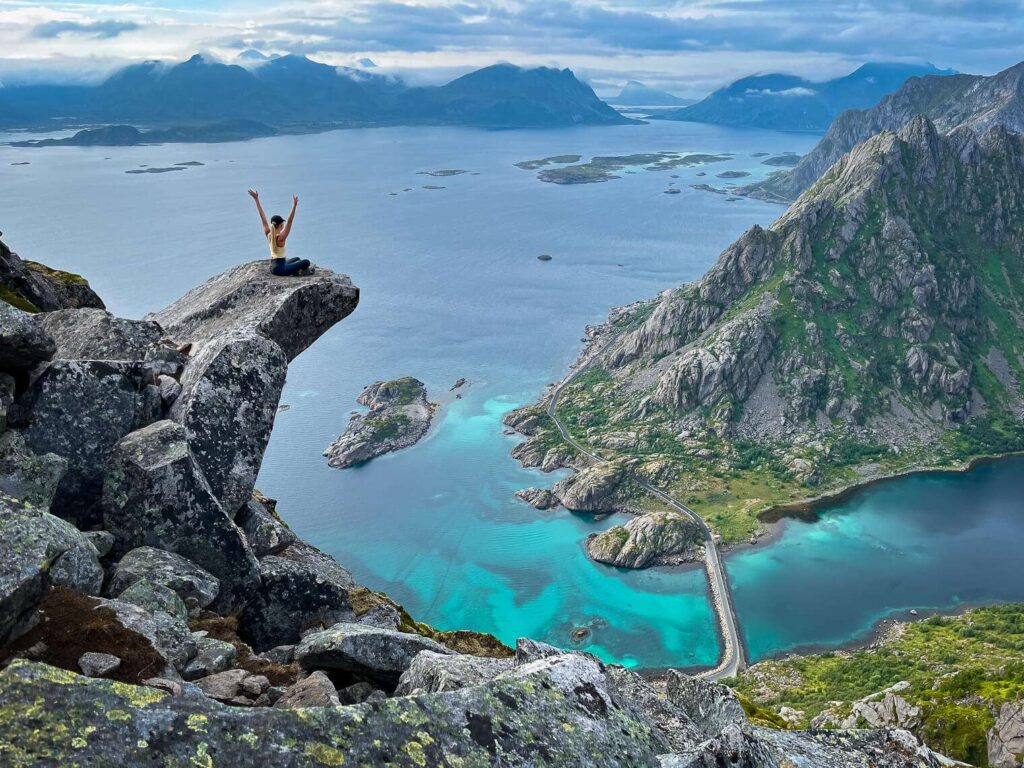 Hiker in waterproof gear trekking a trail in the Lofoten Islands, Norway
