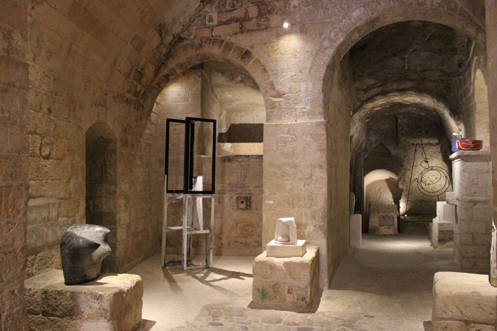 Contemporary sculpture installation inside MUSMA cave museum, Matera