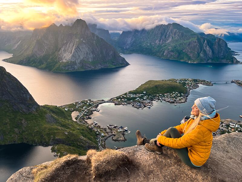 Hiker in waterproof gear trekking a trail in the Lofoten Islands, Norway