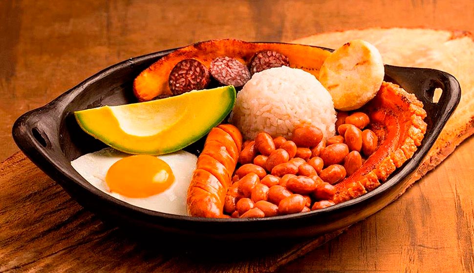 Bandeja Paisa: This massive platter represents the region's agricultural heritage—beans, rice, ground meat, chorizo, fried egg, avocado, arepa, and chicharrón. It's enough food for two people, and it's delicious.