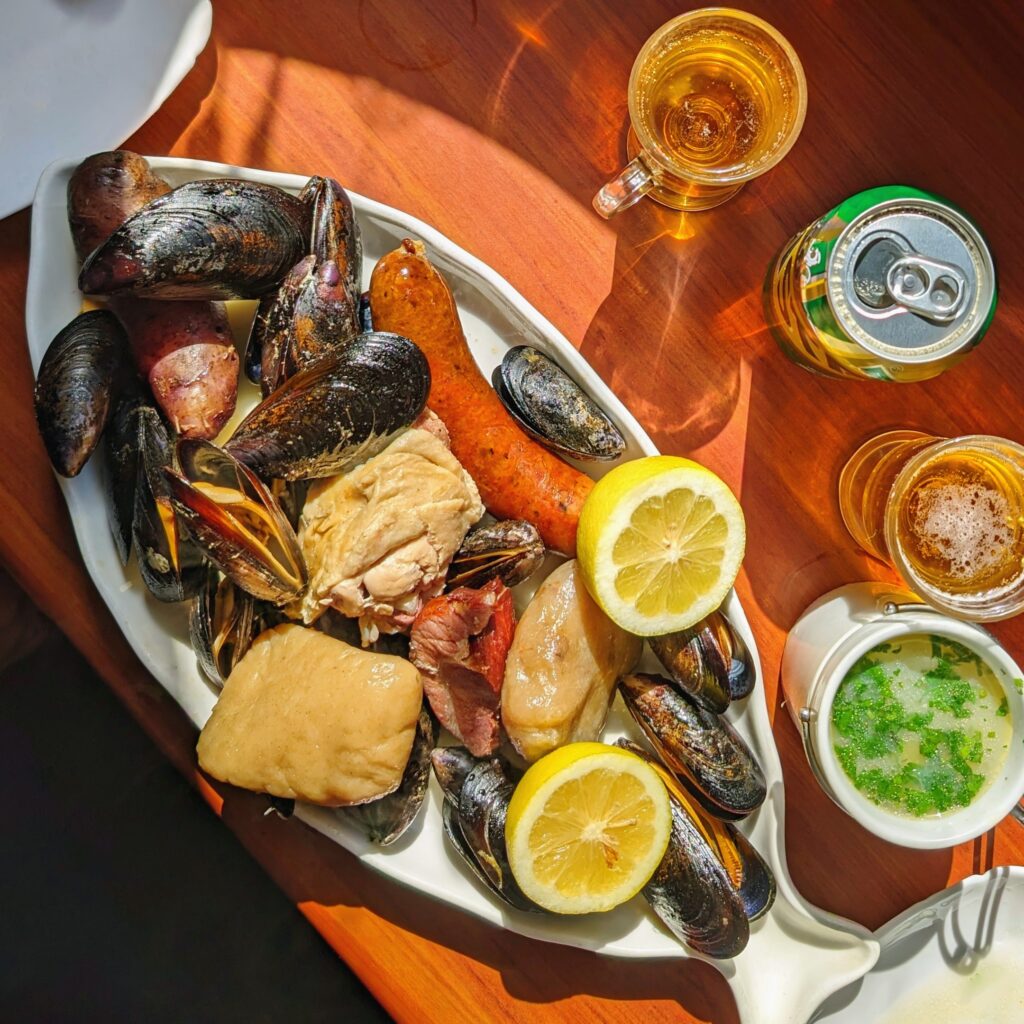 Traditional curanto dish cooked in a pit in Chiloé Island, Chile — potatoes, shellfish and meat