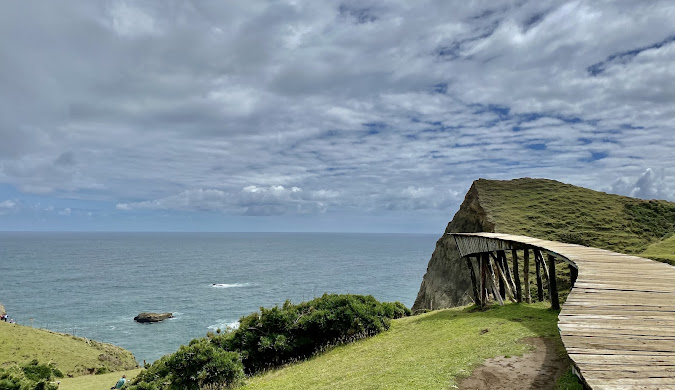 Muelle de las Almas: This wooden dock sculpture extends dramatically over cliffs at Cucao, representing the Chilote legend of souls crossing to the afterlife.